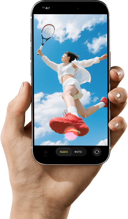 Hand holding a phone shooting a girl with a tennis racket leaping in the sky